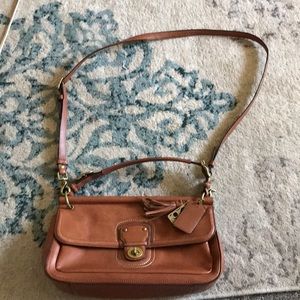 Coach purse with adjustable strap.